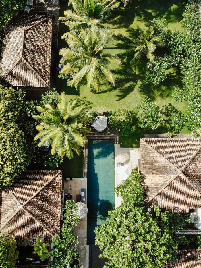 Aerial shot of lush gardens, villas, and a swimming pool in Galle, Sri Lanka.
